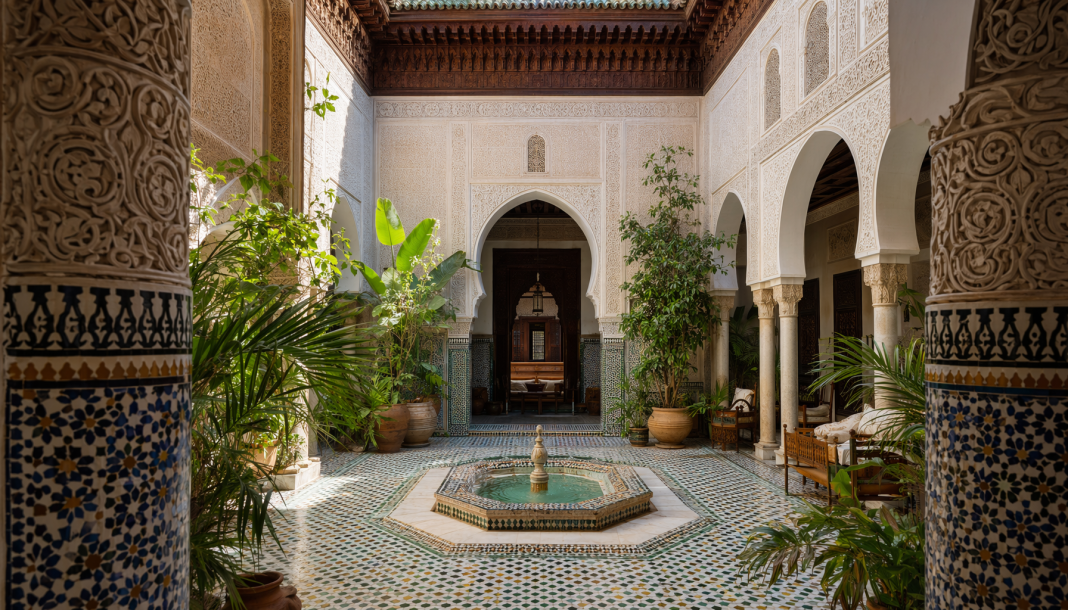 architecture Détail architectural d'un patio de riad marrakchi avec fontaine en zellij, motifs géométriques et lumière naturelle filtrant depuis le ciel ouvert